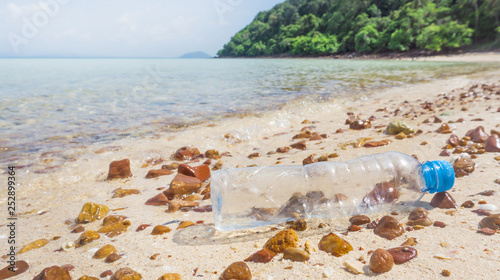Junk plastic bottle on sand beach
