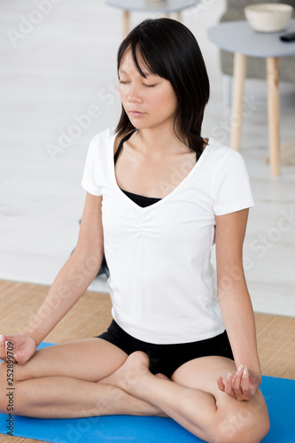 young woman relaxing and practicing yoga