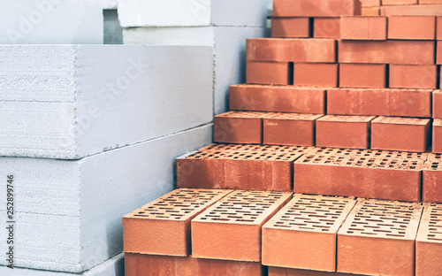 Bricks and aerated concrete blocks. White lightweight concrete block. Red brick. Building material.