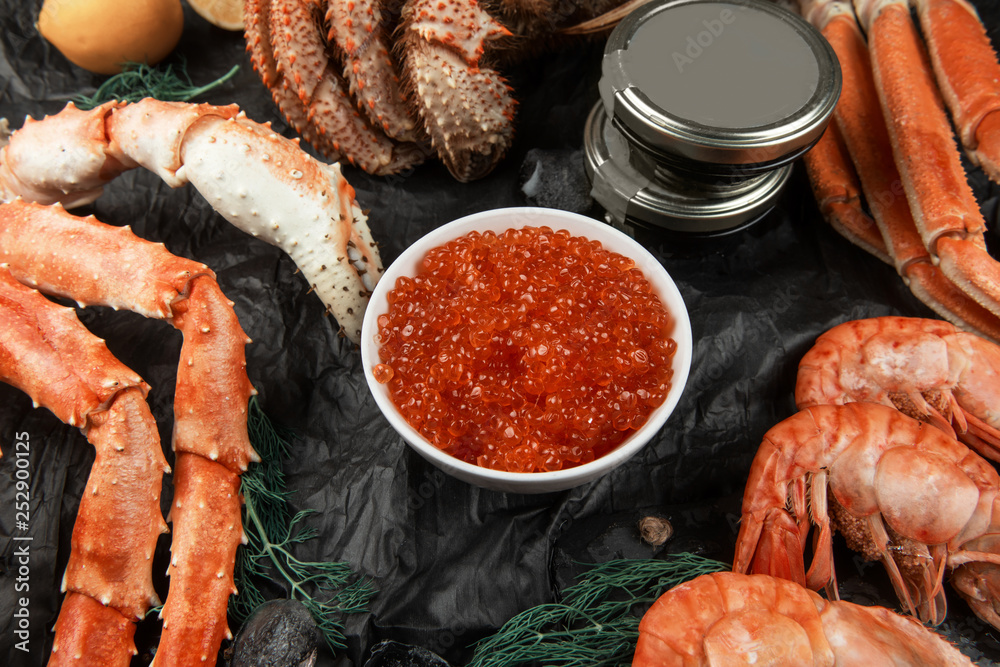 Set of seafood: red and black caviar, limb of hairy crab, limb of snow crab, far eastern kamchatka crab