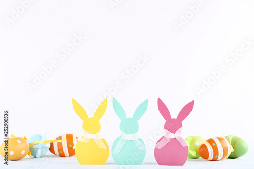 Easter rabbits and painted eggs on white background