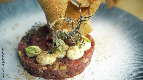 Polish national dish of Tatar, raw beef meat with egg and seasonings
