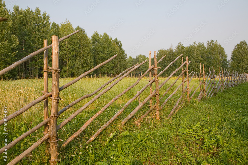 Fence in the Arkhangelsk village. Russia
