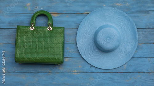 green handbag and blue hat