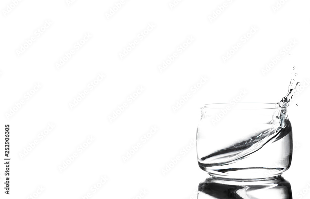 Splash of water in a glass cup on a white background