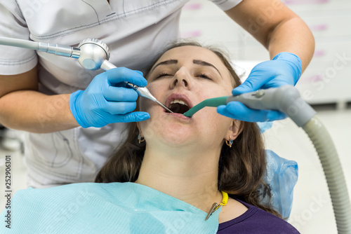 Woman patient in dentistry making whitening procedure