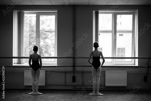 Ballerina doing stretching in the dance hall. Close-up of a ballerina in the dance hall. Black and white photography.