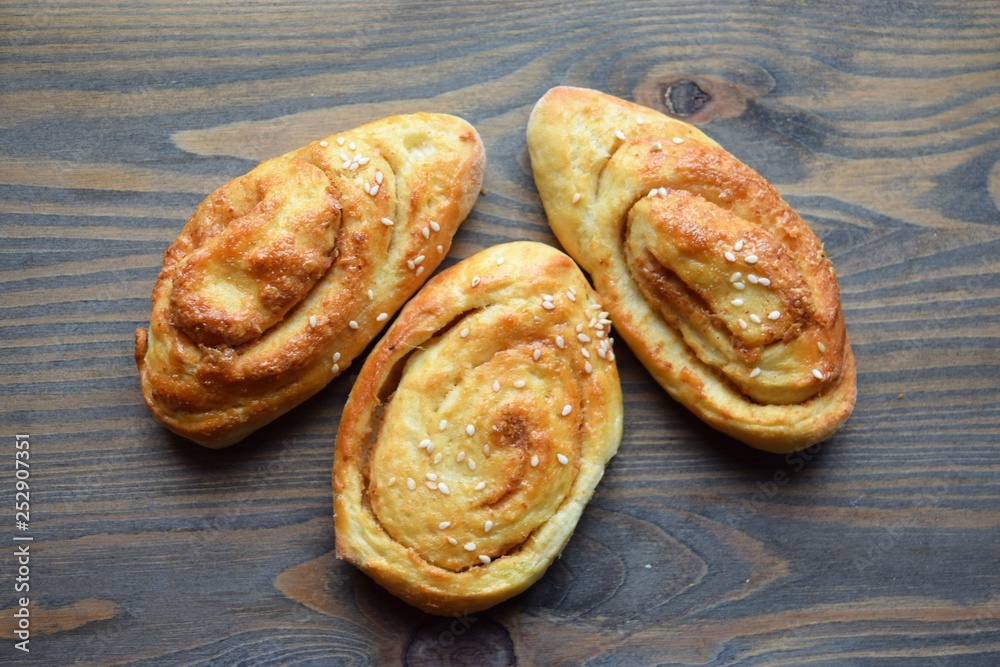 Fresh salt cake with cheese and garlic on a wooden table Fresh salt cake with cheese and garlic on a wooden table