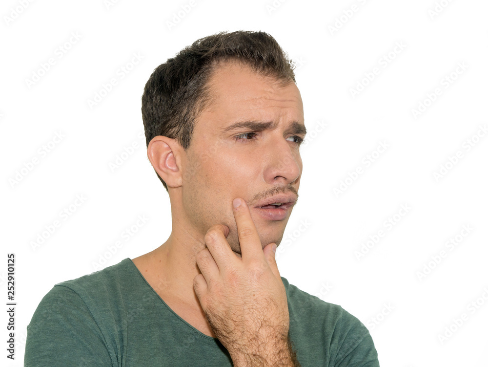 Portrait of young man having terrible pain in his teeth. Isolated on white background in studio Portrait of young man having terrible pain in his teeth. Isolated on white background in studio
