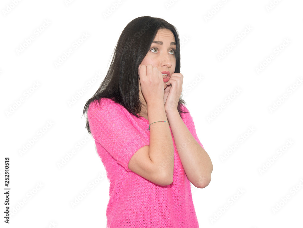 beautiful young girl with dark hair is nervous and bites nails, studio photo isolated on a white background beautiful young girl with dark hair is nervous and bites nails, studio photo isolated on a white background