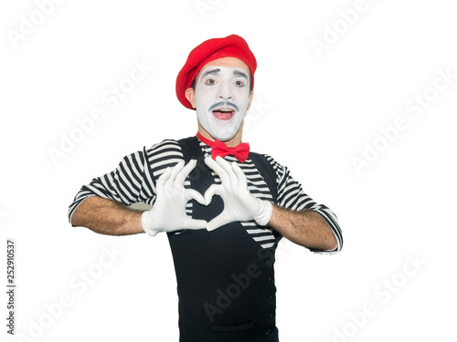 Man in striped sweater, white gloves showing love sign by hands. Clown, artist , mime.Isolated on white background © COK House