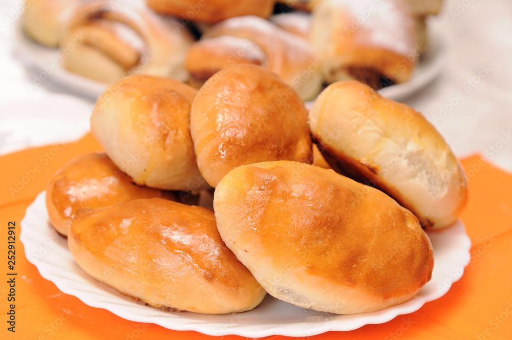 a stack of buns on a white plate a stack of buns on a white plate