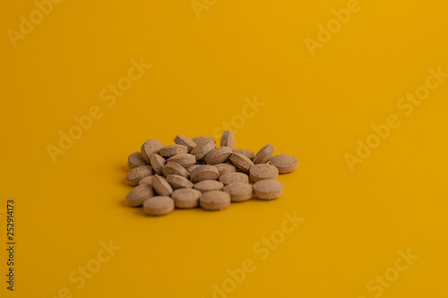 pills in yellow background