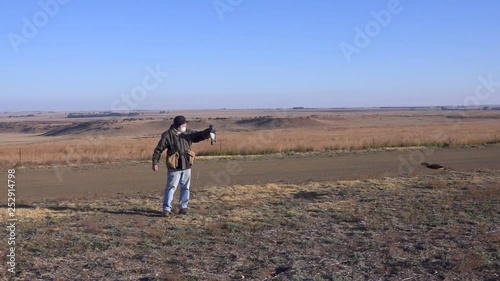 Wallpaper Mural Man and Hawk Eagle train in arid grassland shot in slow motion Torontodigital.ca