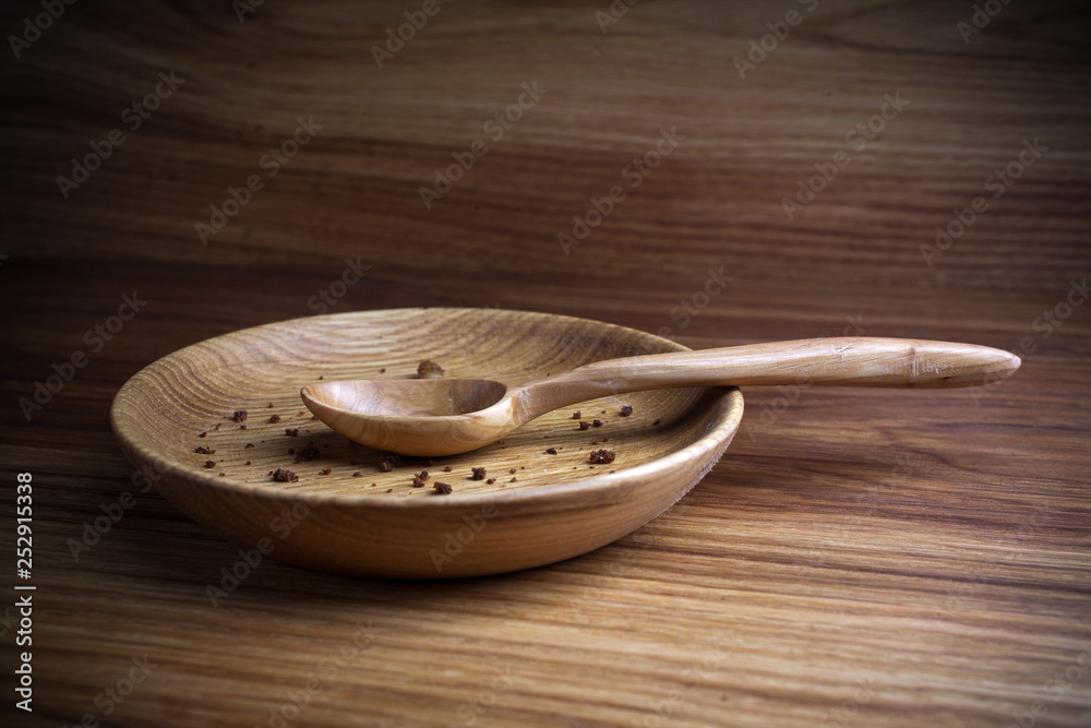 Fasting, Lent. Plate with spoon and crumb on wooden background Fasting, Lent. Plate with spoon and crumb on wooden background