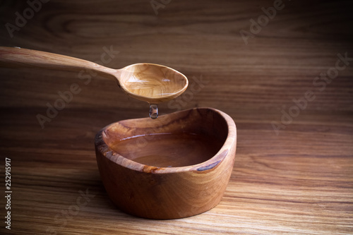 Fasting, Lent. Spoon and cup of water on wooden background