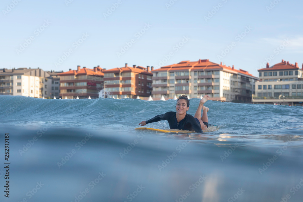  smiling girl paddling on a longboard  