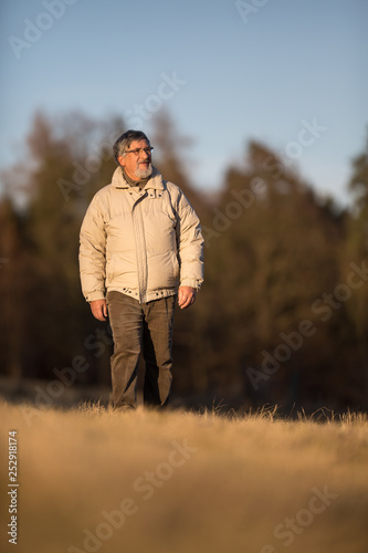 Portrait of a senior man walking outdoors on a cold winter day