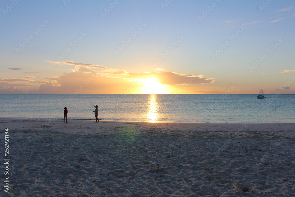 Some children at sunset in the Blue Lagoon Beach in Nacula Island, Yasawa, Fiji