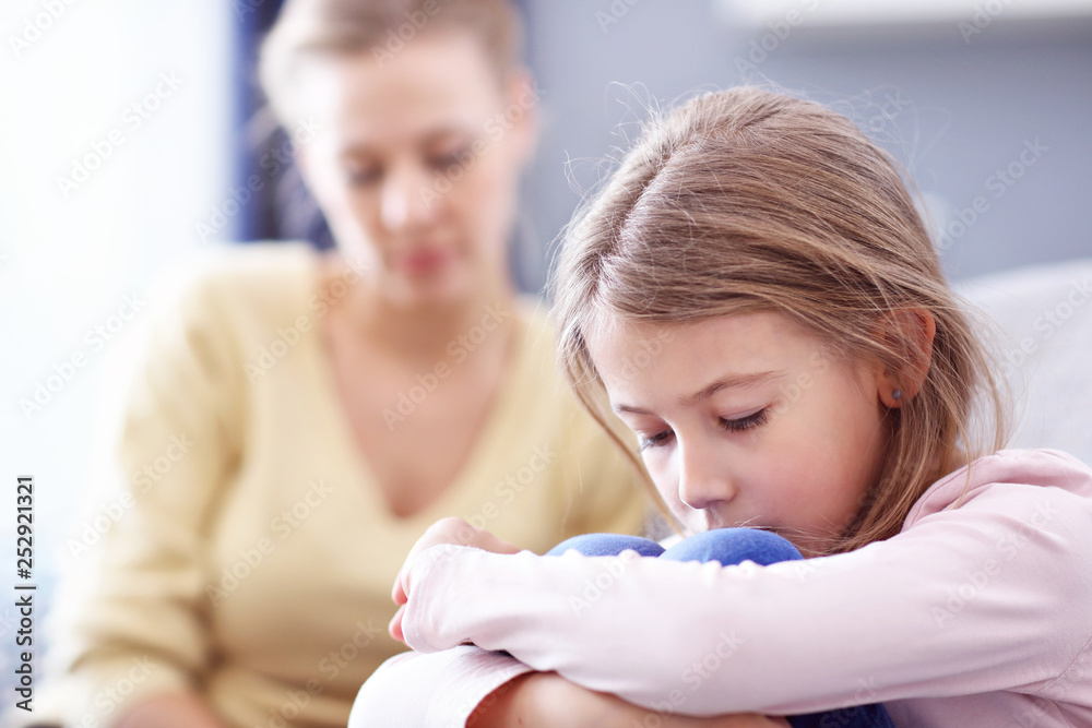 Sad little girl and her mom at home Sad little girl and her mom at home