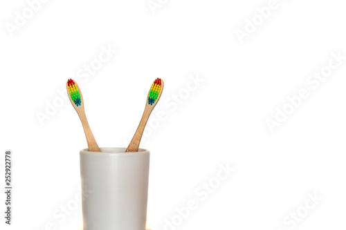 Two eco bamboo toothbrush on white background with copy space