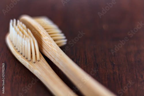 Bamboo toothbrushes on wooden table. Zero waste and Sustainable lifestyle concept