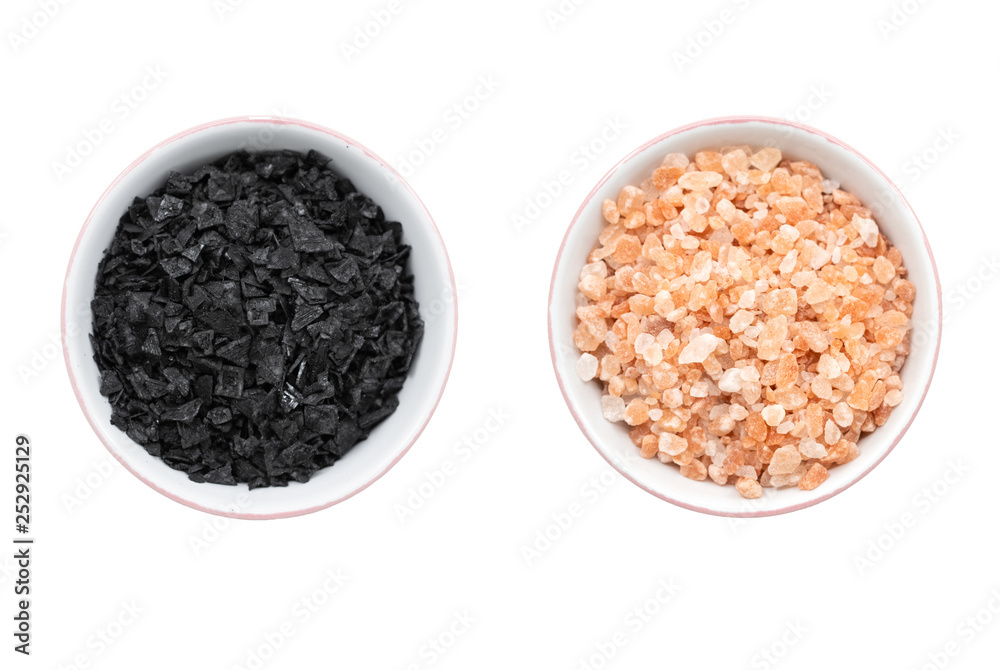 A bowl of himlayan pink salt next to a bowl of mediterranean sea salt A bowl of himlayan pink salt next to a bowl of mediterranean sea salt