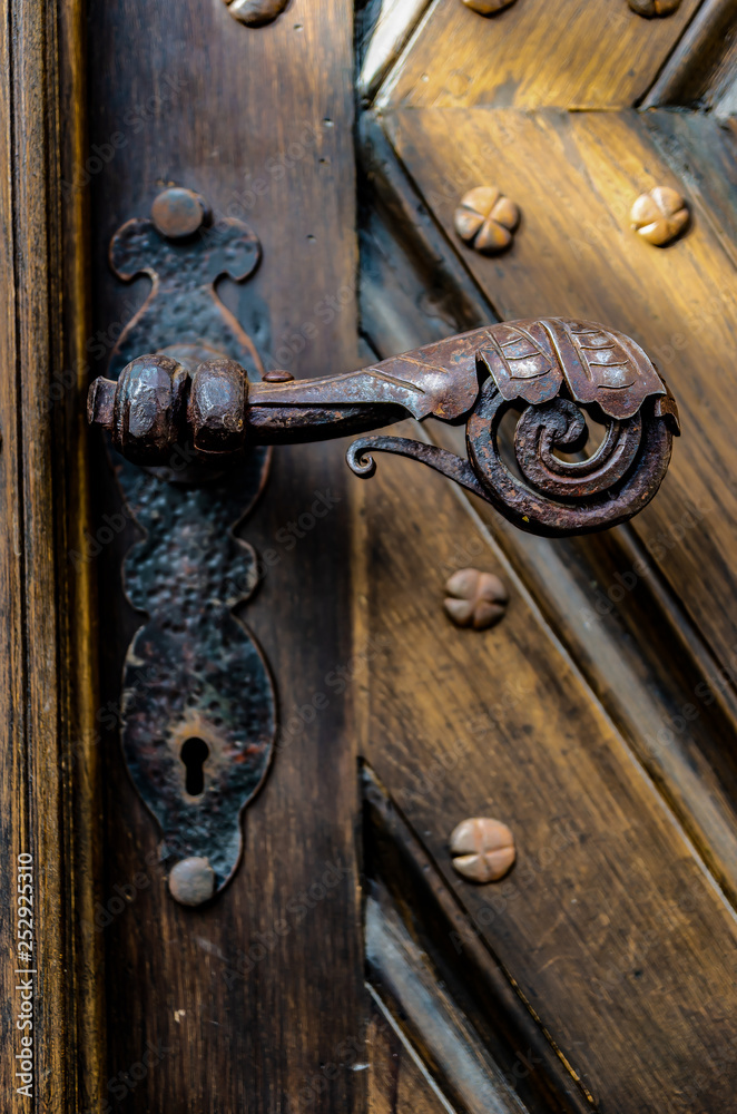 Antique iron forged door handle from the front door. Antique iron forged door handle from the front door.