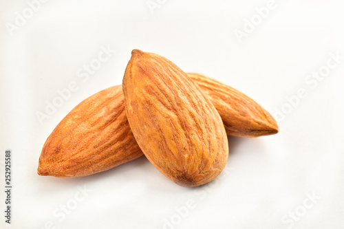 Closeup of almonds, isolated on the white background.