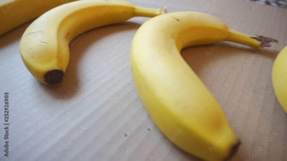 ripe banana fruits lie on the cardboard surface.view from above ripe banana fruits lie on the cardboard surface.view from above