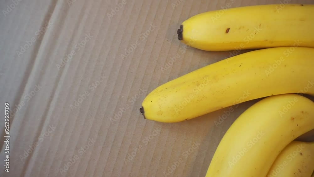 ripe banana fruits lie on the cardboard surface.view from above ripe banana fruits lie on the cardboard surface.view from above