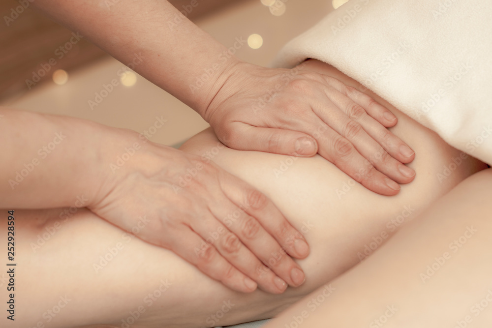 hands masseur doing anti-cellulite massage on the legs of a young girl. hands masseur doing anti-cellulite massage on the legs of a young girl.