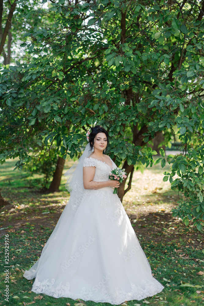 Beautiful bride in a gorgeous dress and bouquet.