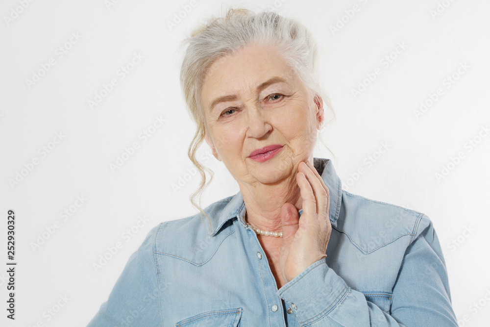 Closeup of smiling senior woman wrinkle face and gray hair. Old mature lady touching her wrinkled skin isolated on white background. Copy space Closeup of smiling senior woman wrinkle face and gray hair. Old mature lady touching her wrinkled skin isolated on white background. Copy space