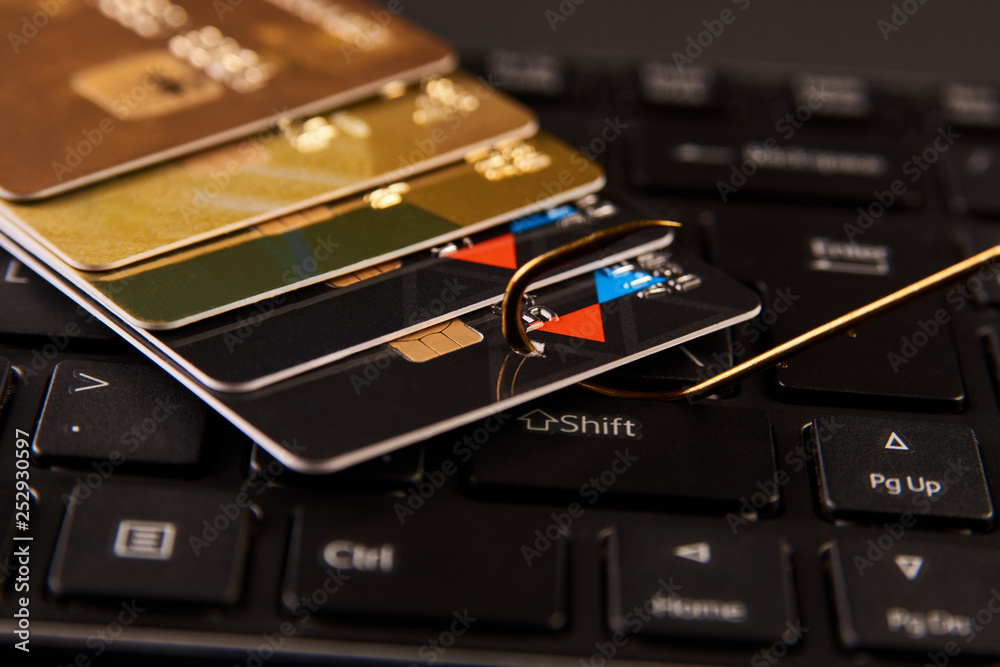 Credit card phishing attack over dark background, close-up