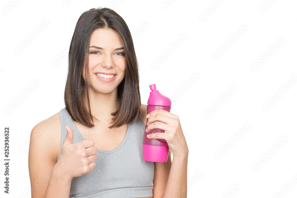 It is all about health. Beautiful young woman holding a bottle of water showing thumbs up smiling happily isolated on white copyspace on the side It is all about health. Beautiful young woman holding a bottle of water showing thumbs up smiling happily isolated on white copyspace on the side