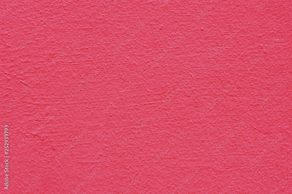 Fototapeta premium Background of a yellow pink coated and painted exterior, rough cast of cement and concrete wall texture
