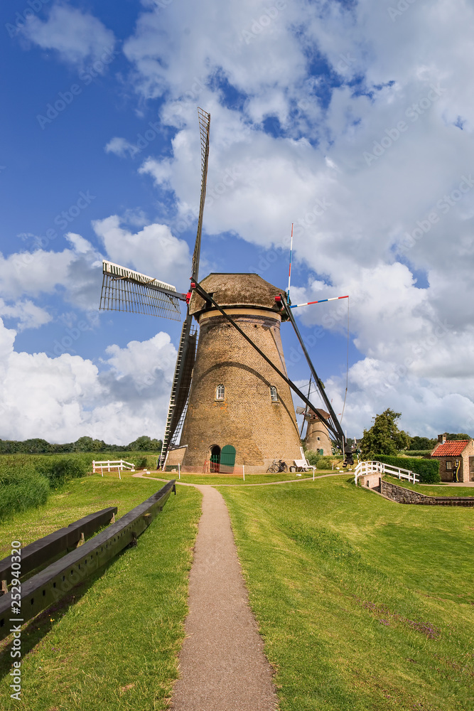 Path to ancient wind mill on a summer day at famous Kinderdijk, Netherlands