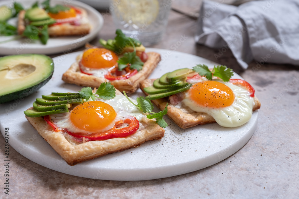 Baked puff pastry with fried egg, pepper and avocado Baked puff pastry with fried egg, pepper and avocado