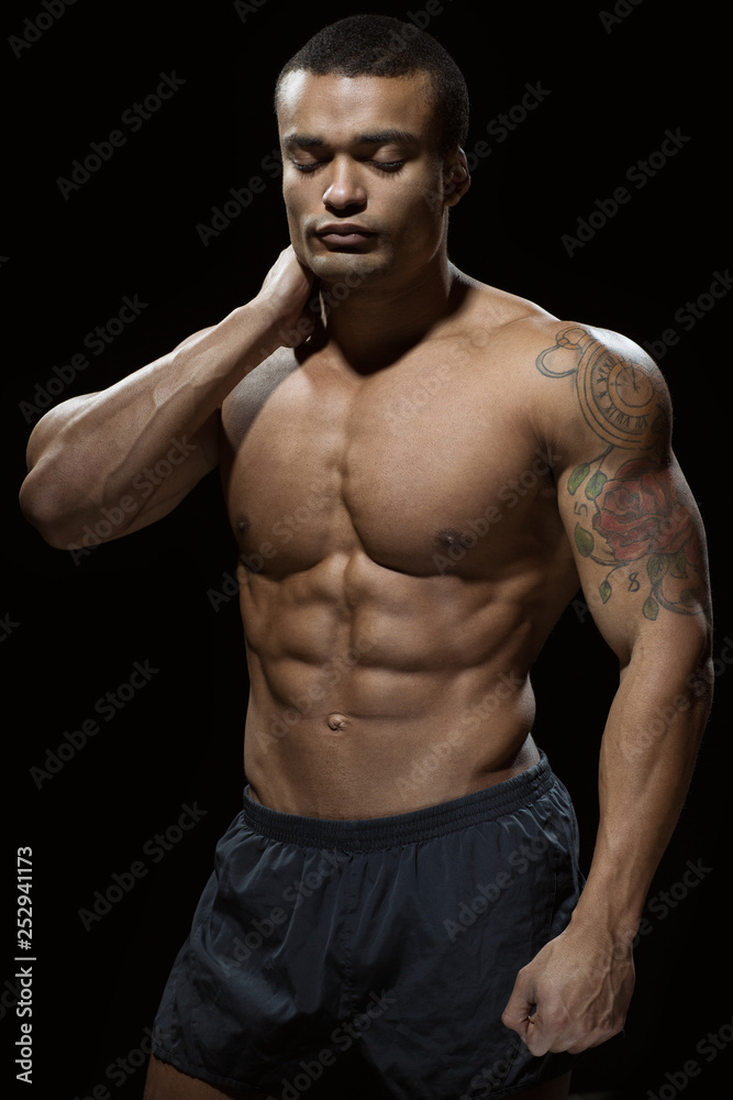 Fototapeta premium Dedication itself. Portrait of defined young African man with ripped abdominal