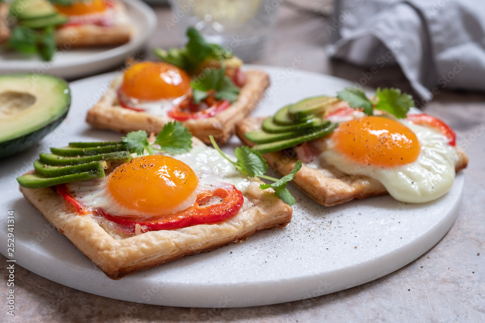 Baked puff pastry with fried egg, pepper and avocado Baked puff pastry with fried egg, pepper and avocado
