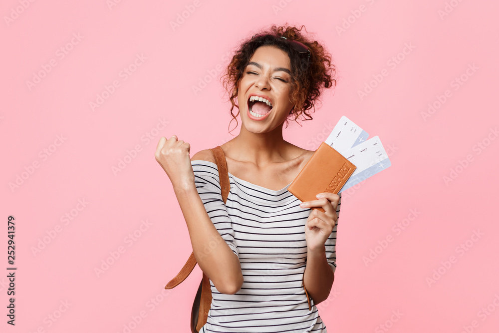 Overjoyed woman with tickets screaming, clenching fist like winner Overjoyed woman with tickets screaming, clenching fist like winner