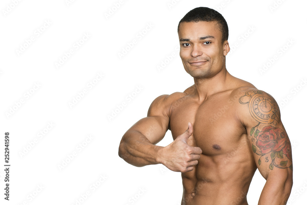 Good job! Portrait of an attractive African man with muscular torso showing thumbs up and smiling Good job! Portrait of an attractive African man with muscular torso showing thumbs up and smiling