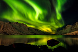 Fire on the sky - northern lights over Ersfjord with beautiful reflection, Kvaløya, Norway