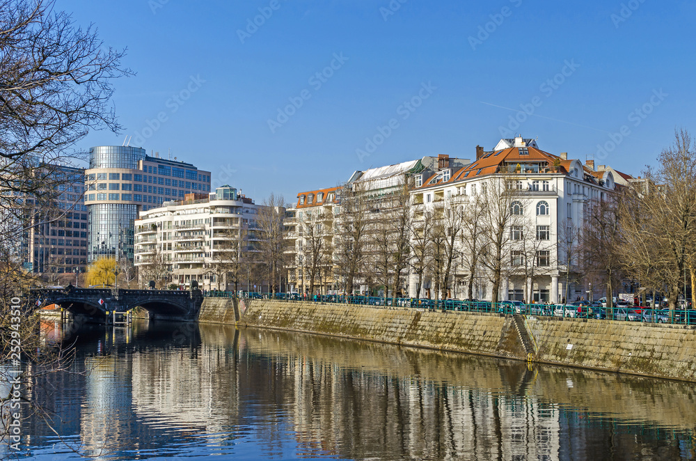 River Spree embankment Helgolaender Ufer with the Moabiter bridge, Spree-Bogen and the building of the former Bundesministerium in Berlin