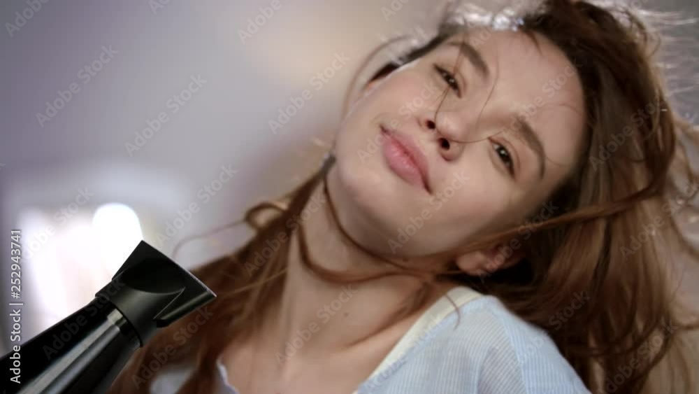 Sensual woman face drying hair. Cheerful girl face enjoy haircare. Female beauty