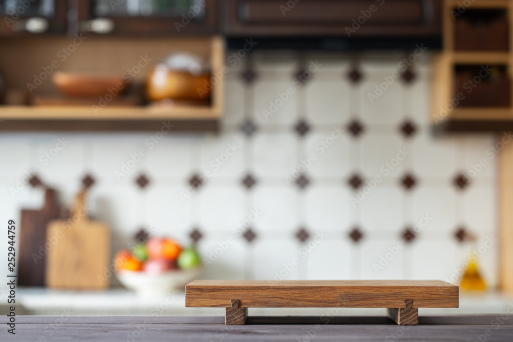 Cutting board on table over blurred home kitchen