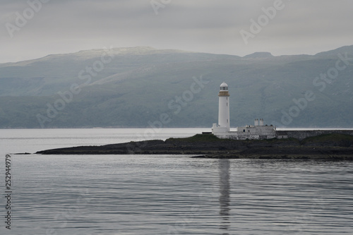 Lismore Lighthouse on Eilean Musdile Islet off Lismore Island on the Firth of Lorn in wet weather with west coast highlands Scotland UK