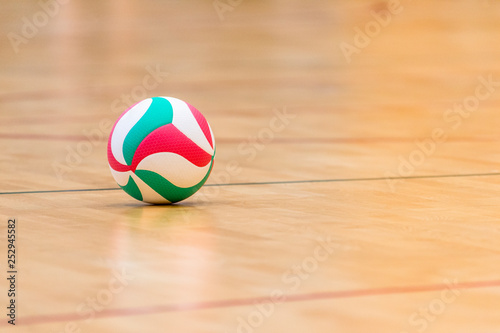 Volleyball ball on hardwood volleyball court