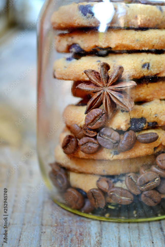 Fototapeta premium Jar of sweet and delicious chocolate cookies with coffee beans and anise stars